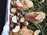 Poulet au parmesan, à l'ail et au citron, légumes au beurre, sur une plaque